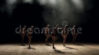 一群年轻的芭蕾舞女在黑暗中<strong>上台</strong>跳舞，特写。 慢点。